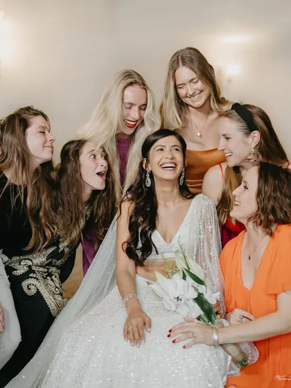 A bride surrounded by her international bridesmaids. We worked with the group to create a cohesive 'all white' theme for the reception, allowing each woman's personal style to shine through.