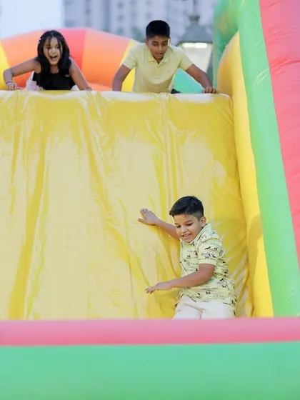 The thrill of a giant inflatable slide! This is always one of the most popular attractions, with kids lining up for their turn to slide down.