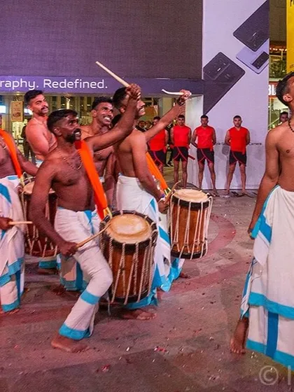 A candid moment of joy and energy from the Chenda Melam drummers. Beyond the main performance, I look for authentic interactions that tell the story of the event.