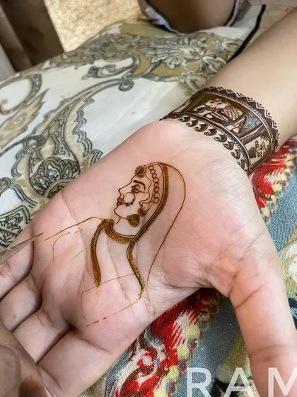 The outlining continues, focusing on the bride's attire and the delicate details of her hands. You can see the portrait coming to life.