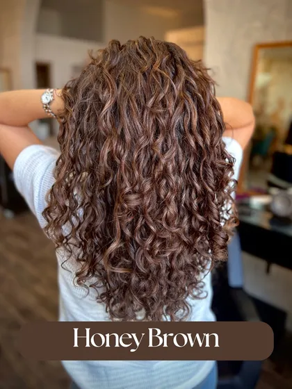 This Honey Brown color on curls is a perfect no-bleach option for summer. The warm tones define the curls and give them a beautiful, sun-kissed glow.