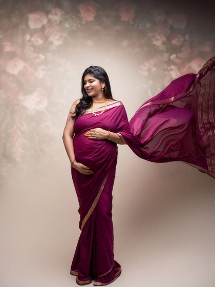 Grace, strength, and the most beautiful journey of all. This frame celebrates the essence of a mother-to-be in a flowing magenta saree.