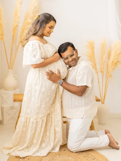 The father-to-be listens to the baby's kicks. It's a classic, heartwarming pose that never fails to capture the magic of pregnancy.