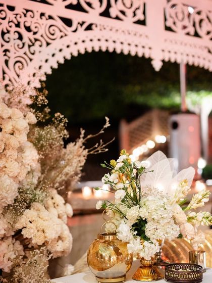 A detail of the white jaali archways and gold lanterns used throughout the Sufi night decor.
