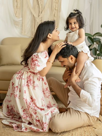 A picture-perfect family. The way the daughter sits on her father's shoulders, with mom looking on, is just beautiful.