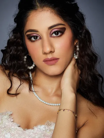 A dramatic look with a blocked-out, heavy brow and sharp cut-crease eyeshadow, perfect for an editorial portfolio.