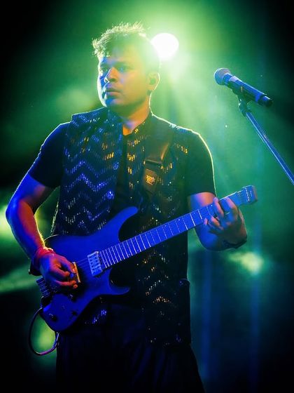 Our electric guitarist, shredding a solo under the spotlight.