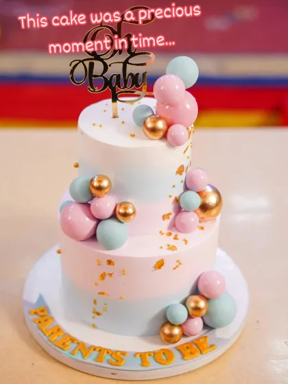 Welcoming a new life is a precious moment. This two-tier baby shower cake features a soft pastel palette with pink, blue, and gold accents. The balloon-like spheres and "Oh Baby" topper make it a beautiful and modern centerpiece for celebrating parents-to-be.