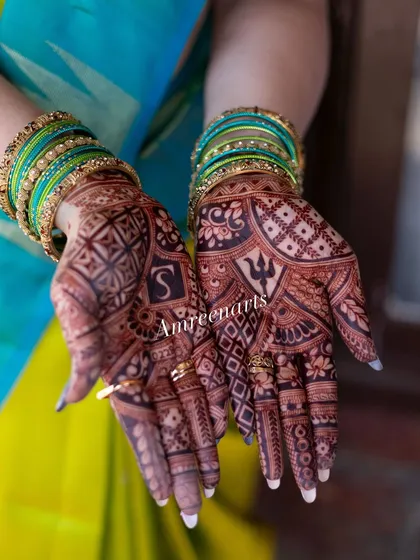 The beautiful contrast between the dark henna stain and the bride's vibrant attire. This is the color you can expect from my work.