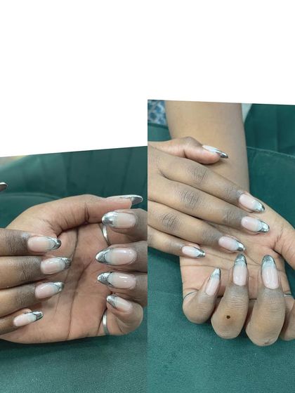 A trendy take on the French manicure using a metallic silver chrome for the tips. This creates a futuristic and eye-catching effect on long almond nails.