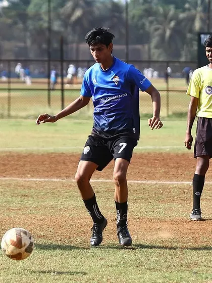 A player looks for a pass while on the ball during an MFA league match.