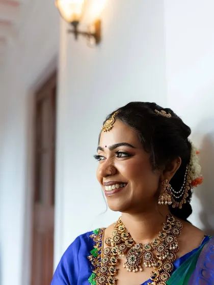 Another angle of this radiant bride, showing how the makeup catches the light to create a beautiful glow. The look is timeless and elegant.