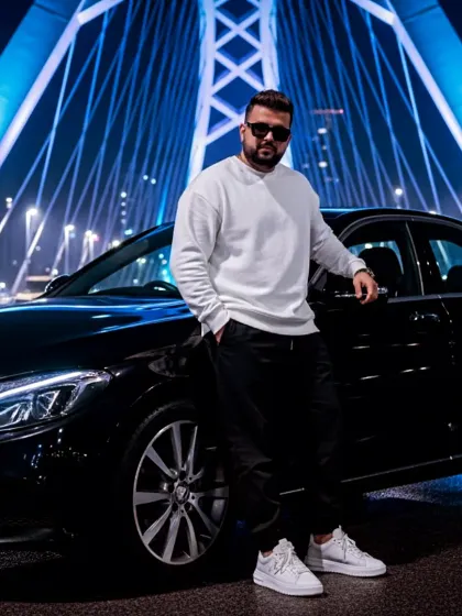 A night shot with a Mercedes-Benz against a lit-up bridge. The city's nightlife is the perfect backdrop and inspiration for my techno and house music tracks.