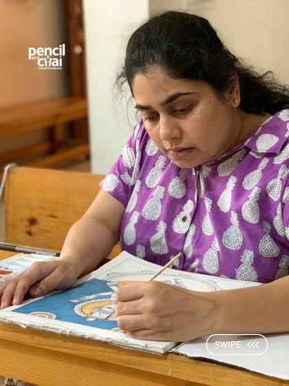 A student is completely absorbed in her Kalamkari painting. The focused, peaceful environment of our studio makes this deep concentration possible.