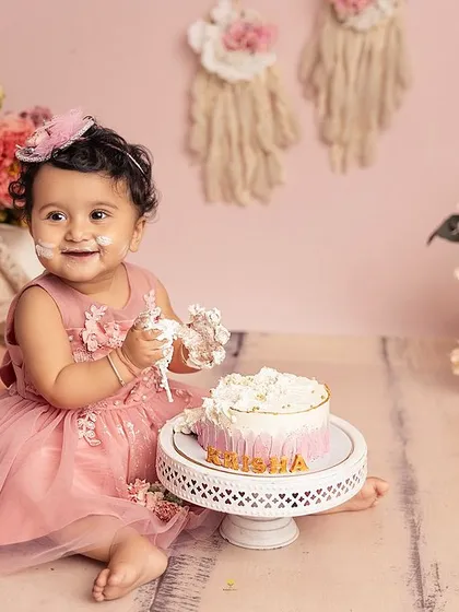 A sweet smile and a handful of cake. This little girl's pink boho-themed first birthday was as adorable as she is, and the photos are a perfect memory of her special day.