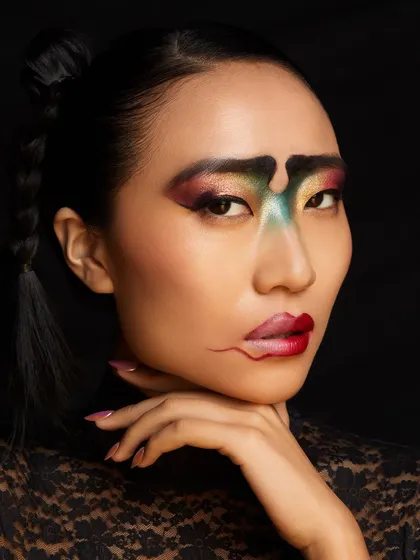 The magic of creative freedom is on full display in this look from our Delhi academy, featuring an abstract, multi-colored design on the eyes and lips.