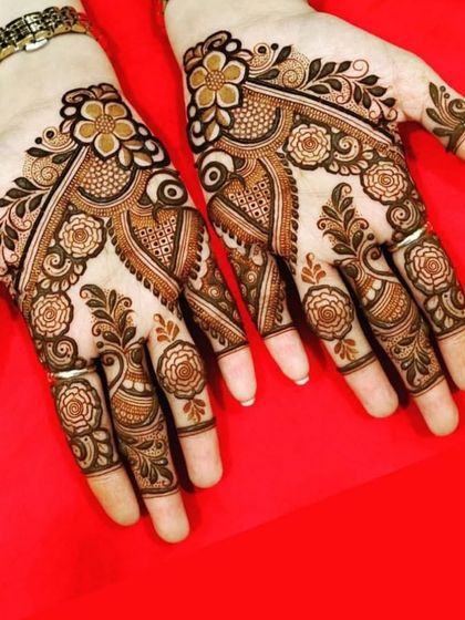 A beautiful floral design with delicate vines and flowers covering the fingers and palms, perfect for any celebration.