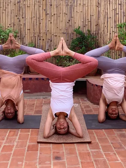 Practicing inversions together brings a sense of play and shared accomplishment. Here, we explore a synchronized wide-legged variation of headstand.