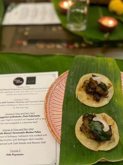 A plated appetizer served on a banana leaf, showcasing the menu for the evening. I love creating multi-course meals that take your guests on a culinary journey.