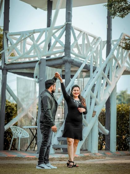 A joyful and dynamic shot of the couple dancing, capturing movement and happiness in their pre-wedding photos.
