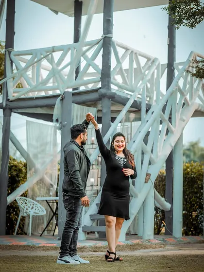 A joyful and dynamic shot of the couple dancing, capturing movement and happiness in their pre-wedding photos.