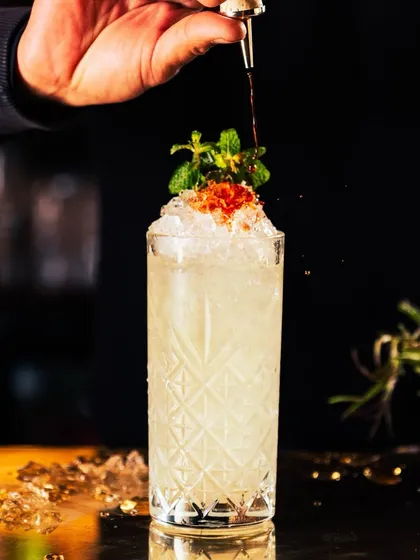 Live the weekend feeling one cocktail at a time. This refreshing drink, topped with crushed ice and fresh mint, is your escape to a world of exquisite taste and innovative mixology.