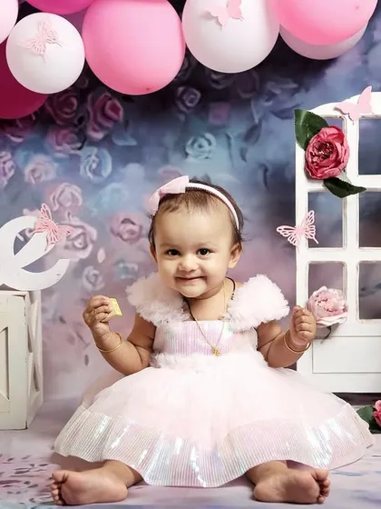 This little girl is enjoying her butterfly-themed first birthday session. The soft colors and whimsical props make for a truly beautiful set of photos.