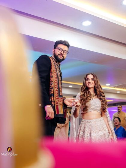 The couple's entrance at their engagement party, a candid moment captured from a unique, low angle.