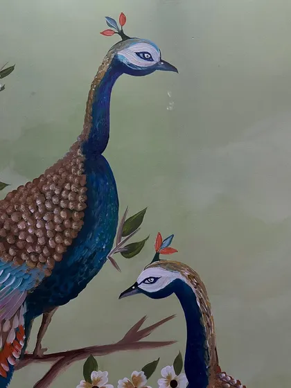 A close-up of the peacocks' heads, painted with a delicate touch.