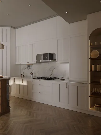 This view highlights the kitchen's ample storage and counter space. An arched, backlit display cabinet provides a beautiful spot for showcasing glassware, while under-cabinet lighting ensures a well-lit workspace.