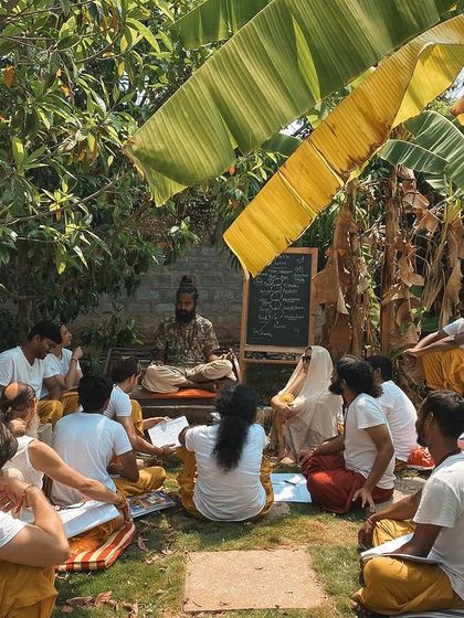 An outdoor philosophy class under the banyan tree. I believe in teaching in a way that is alive and connected to our surroundings. Here, I explain that yoga is the study of "you" to realize you are not just "you."