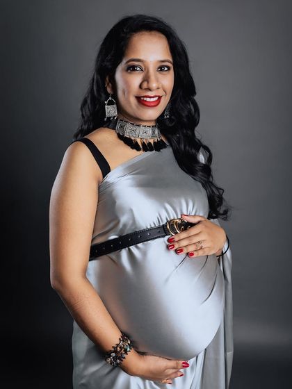 A duplicate of image 55, a stunning studio portrait of a mother-to-be in a modern silver saree.