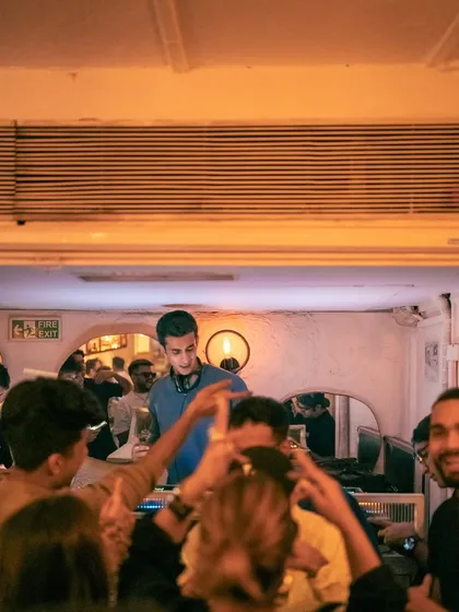 A view from the crowd at Olive, looking up at the DJ booth. It's an intimate venue that creates a great connection.
