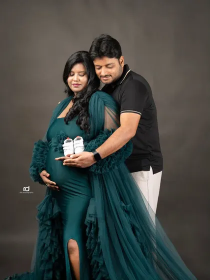 Holding tiny shoes over the baby bump. This classic maternity pose is a sweet and symbolic way to represent the little one you're so excited to meet.