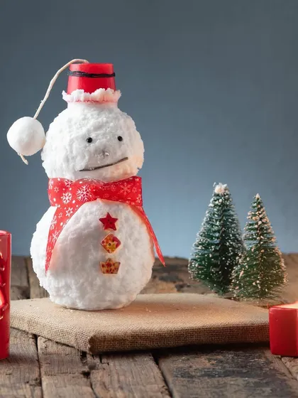 A full-length shot of my adorable snowman candle, complete with a red hat and scarf. He's guaranteed to make you smile.