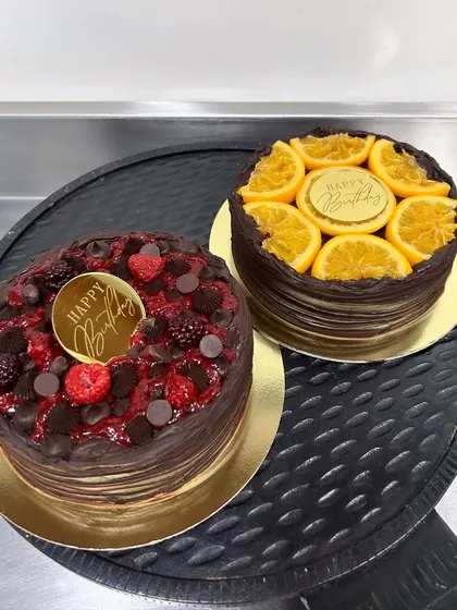 A duo of my diabetic-friendly cakes. On the left is the 3-Berry Belgian Chocolate cake, and on the right is the Belgian Chocolate Orange cake. Both are keto-friendly, gluten-free, and prove that healthy can be incredibly tasty.
