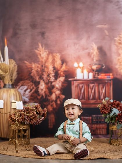 A moment of pure joy in a rustic setting. This little boy's happy expression lights up the warm, candle-lit room, creating a beautiful and timeless portrait.