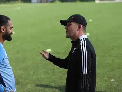 Collaboration is key to athletic development. This image captures a discussion during the FIFA Women's Development Programme, where we connect with other passionate individuals to share strategies and grow the sport.
