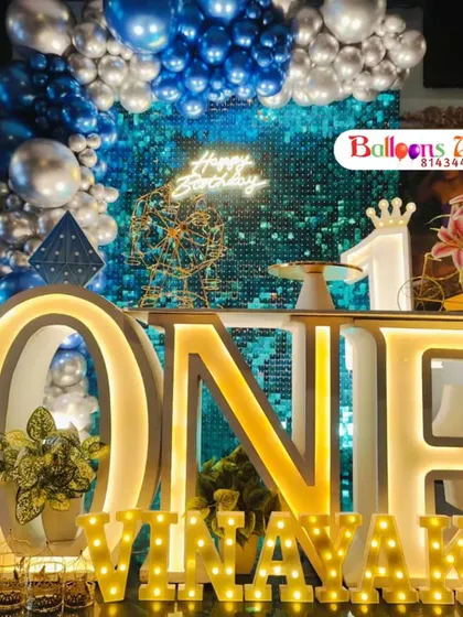 A close-up of the illuminated 'ONE' table, which serves as a fantastic centerpiece and cake display.