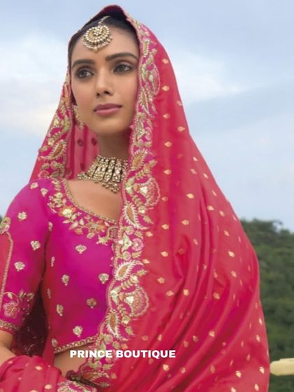 A close-up portrait that highlights the intricate embroidery on the blouse and the beautiful border of the dupatta, along with the stunning bridal jewellery.