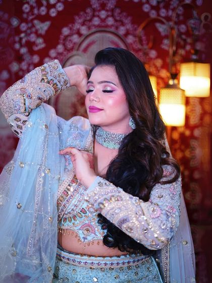 A beautiful pose showing the flow of the dupatta and the detailed work on the sleeves.