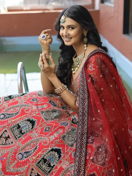 A happy bride enjoying her moment in our red and black embroidered lehenga. Renting allows you to wear such a heavily detailed and unique piece for your special day without the hefty price tag.