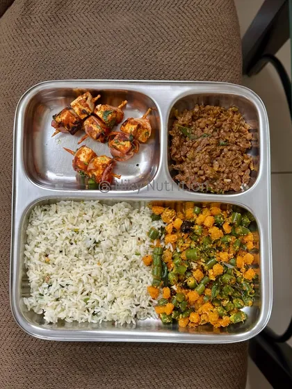 Who says healthy can't be exciting? This plate features delicious paneer skewers, offering a fantastic source of protein, alongside seasoned rice and a mix of vibrant, fiber-rich vegetables. It’s a perfect example of how I make nutritious food that you'll genuinely look forward to eating.