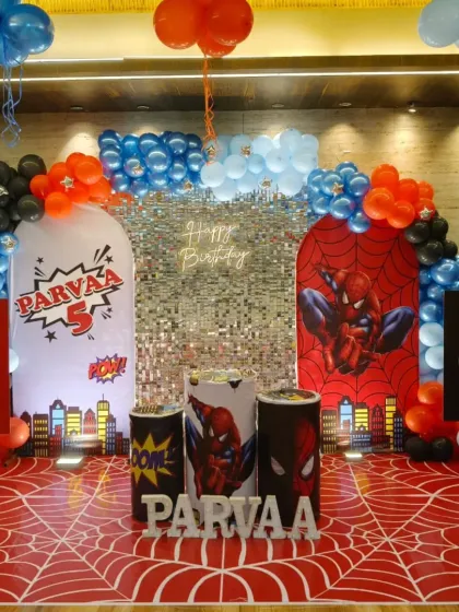 For this 5th birthday, we went all-in on a Spiderman theme. The setup included a custom printed spider-web floor, themed backdrops with a shimmer panel, character cutouts, a neon sign, and balloon arches in signature red, blue, and black.