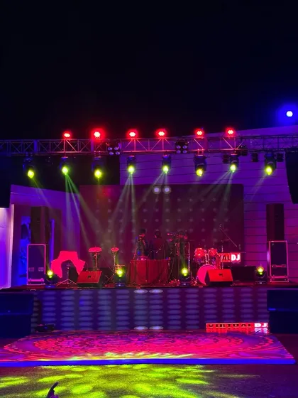 A great corporate party needs the right ambiance. Here is a stage I designed for a cocktail event, complete with a full drum kit for a live band, professional trussing, and vibrant lighting to set a celebratory mood.