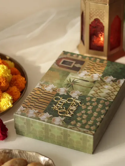 The beautiful green and gold box I use for my Nutty Gujiyas, featuring a 'Happy Diwali' motif.