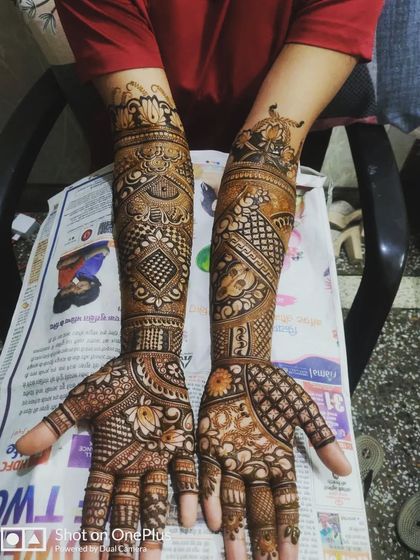 A classic, full-hand design with intricate traditional patterns, showing the rich, dark stain of my natural henna.