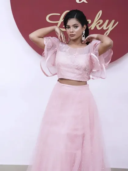 The complete look, a dreamy pink lehenga with soft, romantic makeup and a simple, elegant hairstyle.
