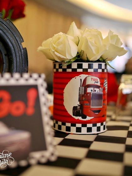 A close-up of the Cars-themed centrepiece, featuring white roses in a custom-printed can with a picture of Mack the truck.