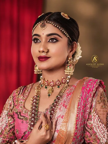 This is my signature Muhurtham look, demonstrated for a makeup course. I focused on creating a classic, timeless portrait that highlights the bride's features with bold lips and perfectly defined eyes.
